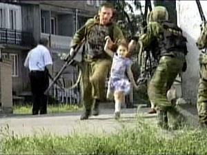 Russian soldiers rescue a child in North Ossetia. AP