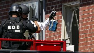 Bomb squad prepare a"water shot" in the apartment of alleged gunman James Holmes July 21