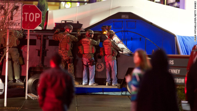 Memebers of a SWAT team take position outside the mall.