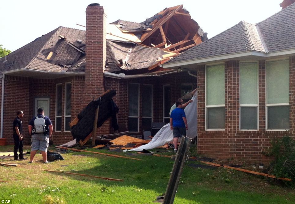 Damage: Residents of Edmond, Oklahoma survey storm damage from a tornado that hit their neighborhood