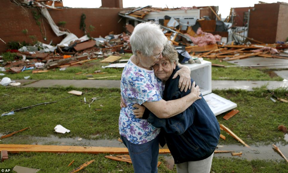 Loss: Jerry Dirks, at right, hugs her friend Earlene Langley after a tornado hit Dirks' home just south of Carney Oklahoma