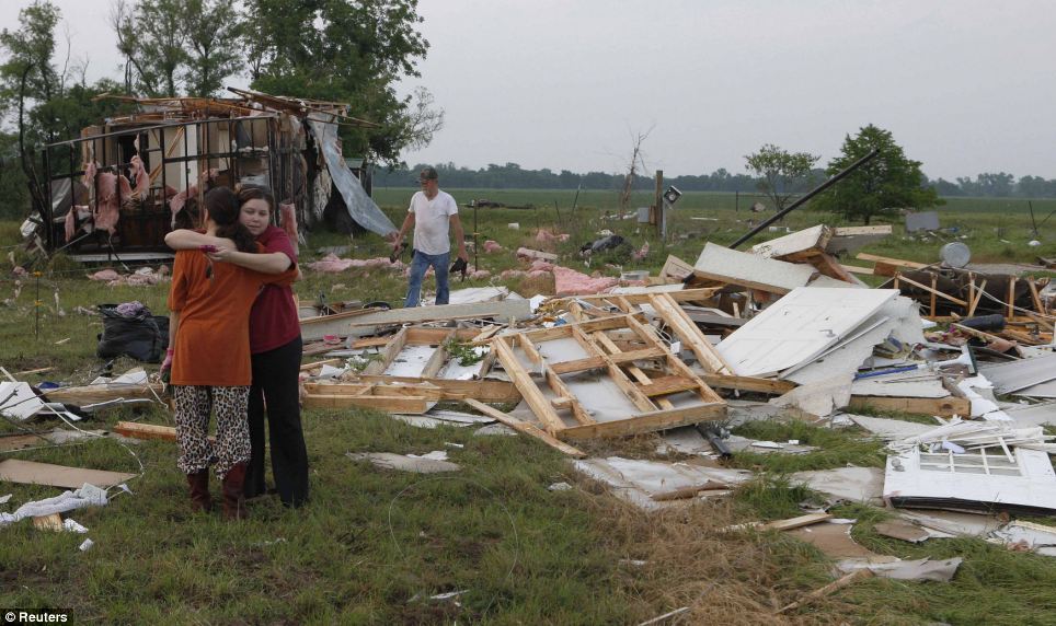 Nothing left: Leah Hill, pictured left, of Shawnee, Oklahoma, is hugged by friend Sidney Sizemore, as they look through Hill's scattered belongings from her home which was wrecked by a tornado