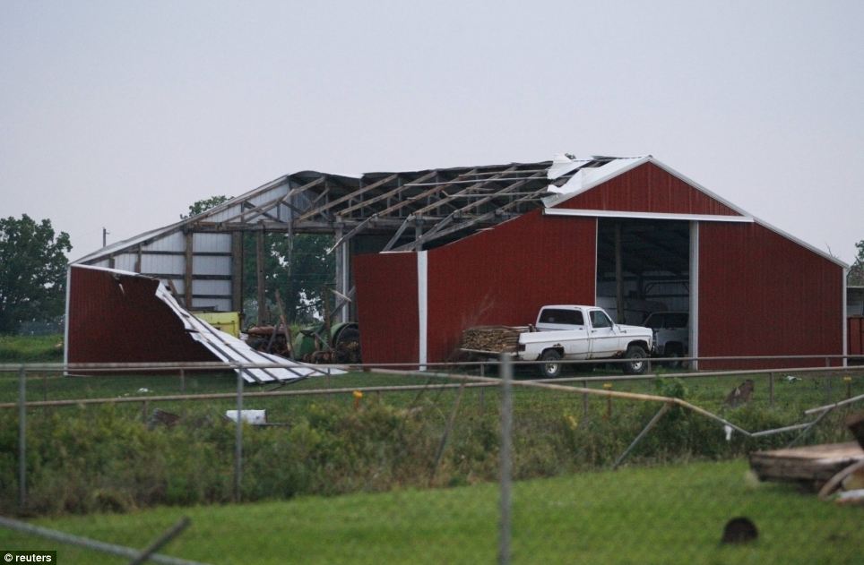 Mighty: A barn's roof and siding is torn off after a tornado swept through west of Shawnee
