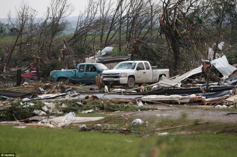 Damage: Vehicles are seen amongst storm debris, which is what is left of a mobile home park destroyed by a tornado, west of Shawnee