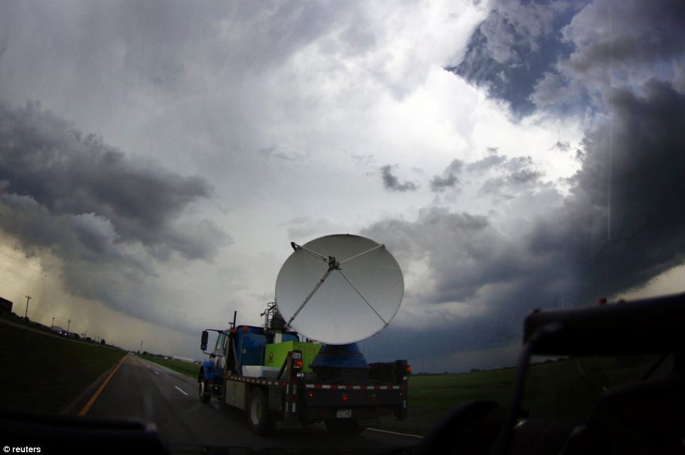 Tracking: A National Oceanic and Atmospheric Administration (NOAA)'s mobile doppler radar mounted on the back of a truck tracks a tornadic thunderstorm 