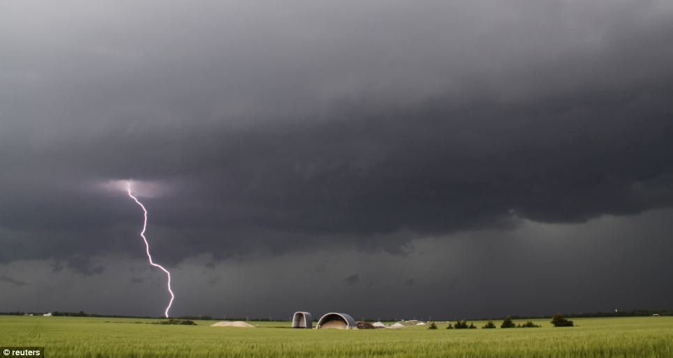 Dramatic: Lightning from a tornadic thunderstorm passing over Clearwater, Kansas strikes at an open field 