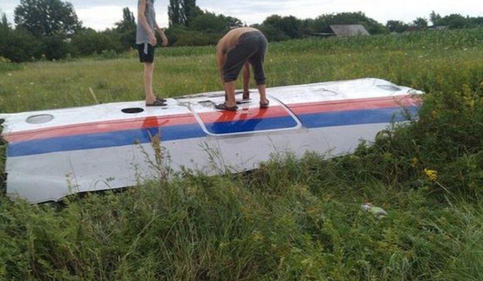 An unverified image posted online show Ukrainian inspecting what appears to be wreckage from the doomed flight