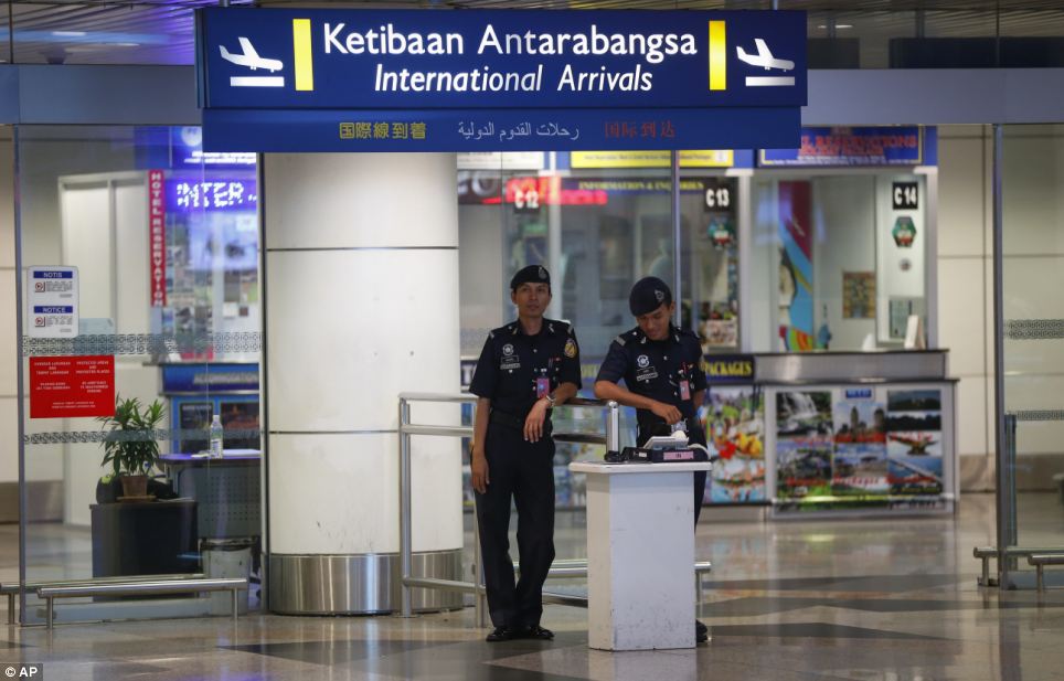 On alert: Airport police stand guard at the arrival hall at Kuala Lumpur International Airport, where the plane had been due to land
