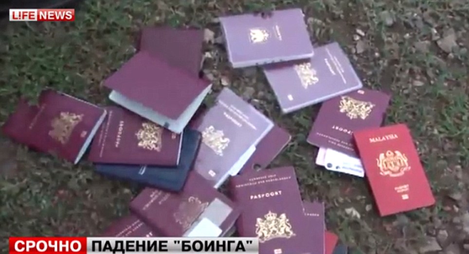 Poignant: Passports of some of the victims. Emergency services rescue worker said at least 100 bodies had so far been found at the scene near the village of Grabovo