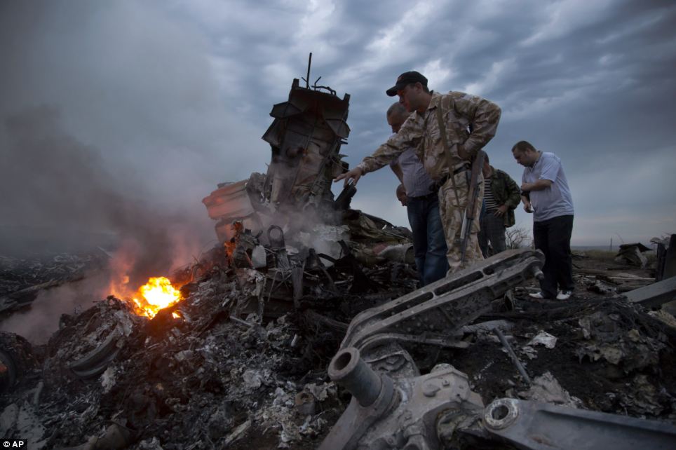 Crash site: Rescue workers inspect the wreckage of a Malaysia Airlines passenger plane which was shot down today above Ukraine, killed all 298 people on board