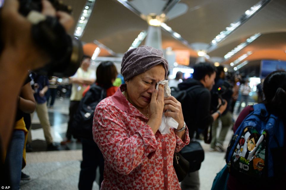 Tearful: The woman reacts to news regarding the tragic plane crash in eastern Ukraine