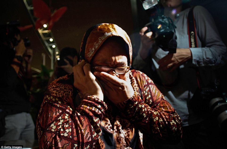 Grief: A family member cries as she receives the news of the ill-fated flight MH17 during a phone call at Kuala Lumpur airport