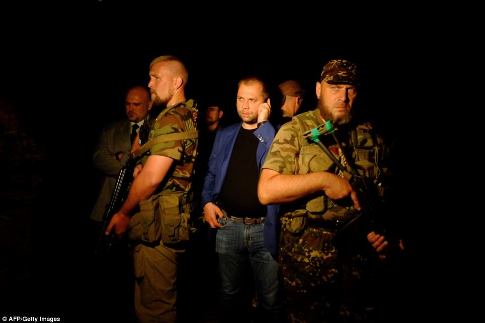 Arrival: The self-proclaimed Prime Minister of the pro-Russian separatist 'Donetsk People's Republic' Alexander Borodai (centre) arrives on the site of the crash