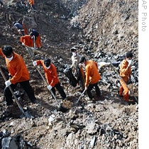 Iranian workers search site where  Russian-made passenger plane crashed near Qazvin, about 75 miles west of Tehran, 15 Jul 2009