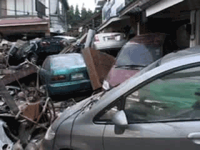 Cars on top of each other after tsunami wrecked them