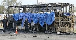 Emergency crews investigate the scene where a bus caught fire and exploded on northbound Interstate 45, Friday, in Wilmer, Texas. The bus carrying elderly evacuees from Hurricane Rita caught fire and was rocked by explosions on a gridlocked highway near Dallas, killing as many as 24 people, authorities said. The bus, with about 45 people on board, had been traveling since Thursday. AP Photo /Matt Slocum